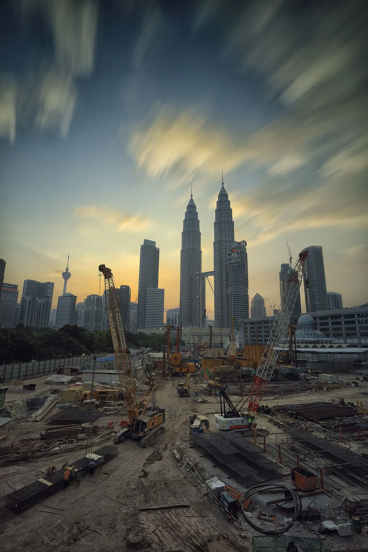 Large construction site with skyline and cranes